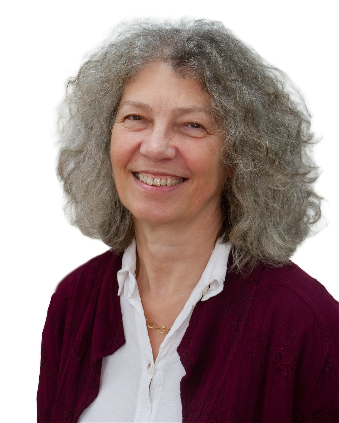 Sonia Livingstone smiling, with gray curly hair, a white blouse and a maroon cardigan