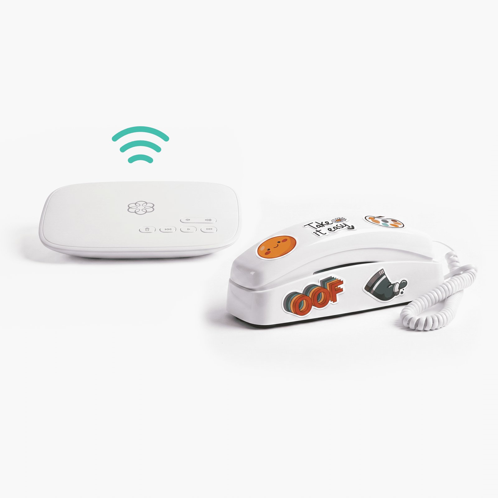 A white Ooma base station with a Wi-Fi symbol above it, next to a white trimline phone covered in stickers that say OOF and Take it easy