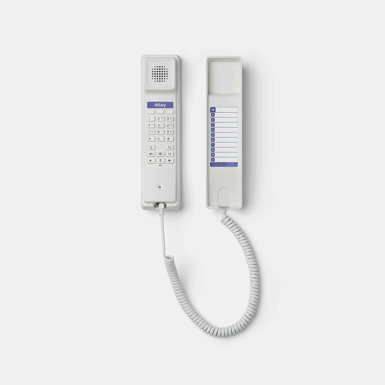 A white Wiley Buddy seen from above with the handset lifted: the keypad on the inside of the handset, and a speed-dial card numbered 0 to 9 on the cradle